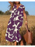 Lumina Wear Alvina relaxed abstract black dress displayed on a hanger, showcasing its modern design and stylish fit.