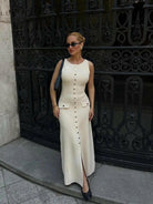 Beige Amaris maxi dress by Lumina Vancouver, suitable for autumn, shown on a mannequin with flowy fabric and long sleeves.