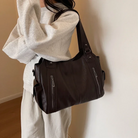 Elegant black shoulder bag by Lumina Wear featuring functional design, suitable for stylish everyday use.