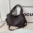 Black Lumina Wear handbag with amber accents, elegant shoulder bag featuring a functional design and stylish look.