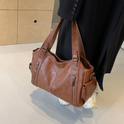 Elegant black Lumina Wear shoulder handbag with functional design, featuring a sleek Amber style with practical compartments.
