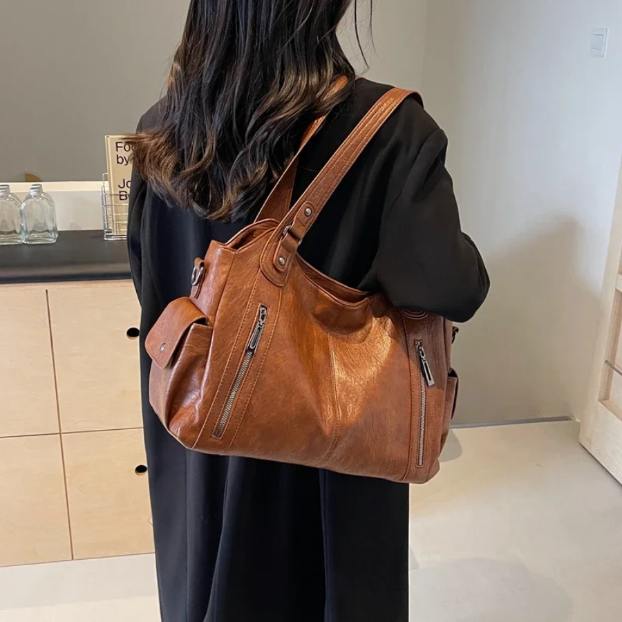 Amber black shoulder handbag by Lumina Wear featuring a sleek design and functional compartments for everyday use.