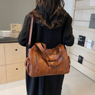 Elegant black shoulder bag by Lumina Wear featuring a functional design and Amber accents, ideal for stylish everyday use.