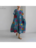 Lumina Wear Amelia floral dress with vibrant flower patterns, sleeveless design, and a flowing silhouette.