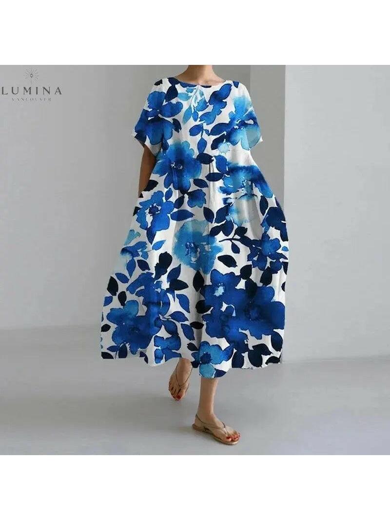 Floral dress by Lumina Vancouver featuring a vibrant pattern and flowy fabric, displayed on a hanger.