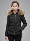 Black Lumina Wear Amelia longline puffer coat with faux-fur hood, sleek design, and quilted insulation for warmth.