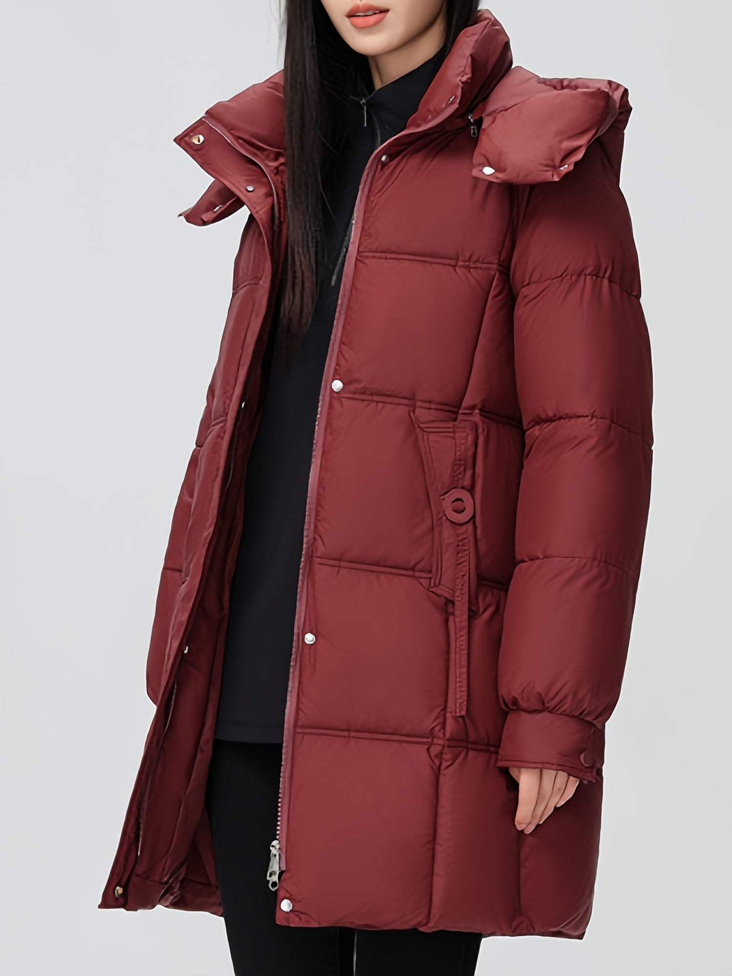 Black Amelia Lumina Wear hooded longline puffer coat with belt, stylish and warm, shown on a model.