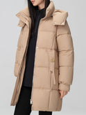 Black Amelia puffer coat by Lumina Wear featuring a hood, longline design, and belt for a stylish winter look.