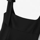 Black Lumina Wear Amelie camisole with bow detail and zipper closure, showcasing elegant design and fitted style.