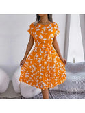 Blue Anabelle floral pleated midi dress by Lumina Wear, featuring a flowing, elegant design perfect for summer occasions.