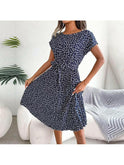 Blue Anabelle floral pleated midi dress by Lumina Wear, shown with flowing fabric and elegant floral pattern.
