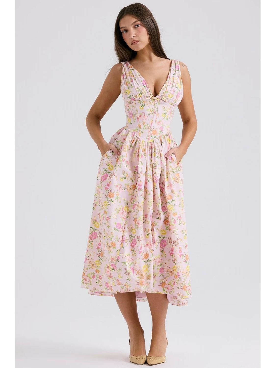 Yellow floral Angelica elegant summer dress by Lumina Vancouver, shown with a flowing fabric and sleeveless design.