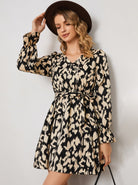Lumina Vancouver Raili A-Line Mini Dress with V-neck, stylish and fitted, showcased on a model in a bright setting.