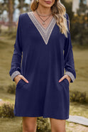 Black mini casual dress with V-neck and lace trim by Lumina Wear, featuring a stylish, relaxed fit and elegant detailing.