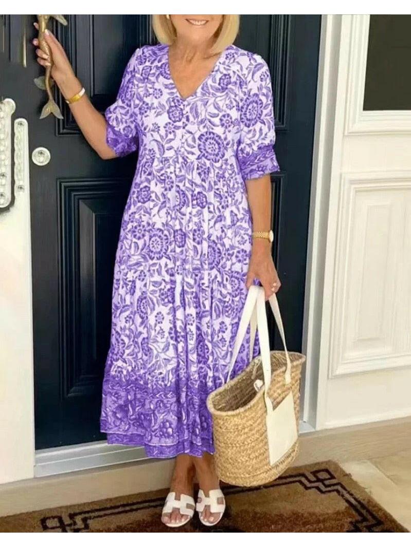 Blue ARIA™ floral dress with V-neck by Lumina Vancouver, showcasing elegant design and delicate floral pattern.