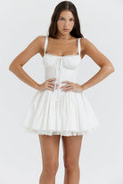 White mini dress by Lumina Vancouver featuring a lace-trimmed bodice and short sleeves, perfect for casual or dressy occasions.