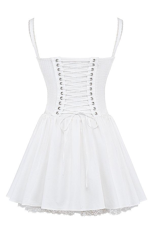 White mini dress by Lumina Vancouver with lace trim bodice, showcased on a hanger with a focus on the detailed lace design.
