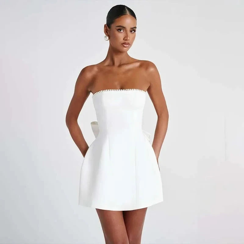 White strapless satin mini dress by Lumina Vancouver featuring a fitted silhouette and elegant design.