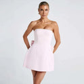 Strapless satin mini dress by Lumina Wear in white, showcased on a model with a smooth, fitted silhouette and elegant style.