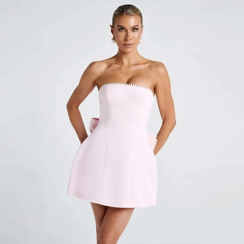 White strapless satin mini dress by Lumina Vancouver, featuring a fitted silhouette and elegant design.