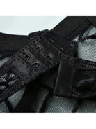 Lumina Vancouver Tellervo Bodysuit in black, close-up of fitted, sleek design with scoop neckline and long sleeves.