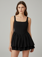 Black satin mini dress with square neckline by Lumina Vancouver, featuring a fitted silhouette and elegant design.
