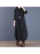 A medium-length red grid shirt dress by Lumina Vancouver featuring a collared neckline and button-front design.