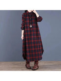 A red grid-patterned medium-length shirt dress by Lumina Wear, featuring a collar, button front, and relaxed fit.