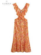 Orange Ariella floral ruffle dress by Lumina Vancouver, perfect for holiday vibes, size 4-6XS, with floral and ruffle details.