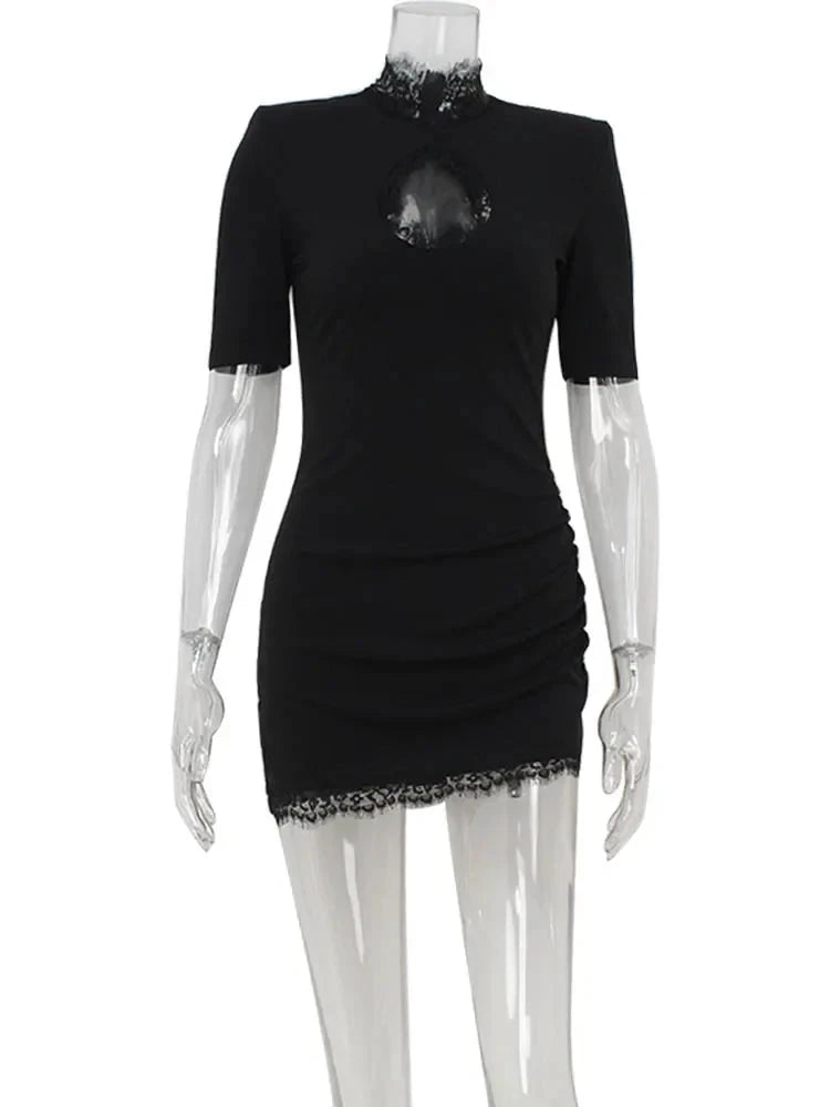 Black Nanna mini dress with bodycon fit from Lumina Vancouver, shown on a model, highlighting its sleek, form-fitting design.