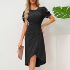 Black Ragnhild mini dress with puff sleeves from Lumina Vancouver, shown on a model with a fitted silhouette and stylish design.