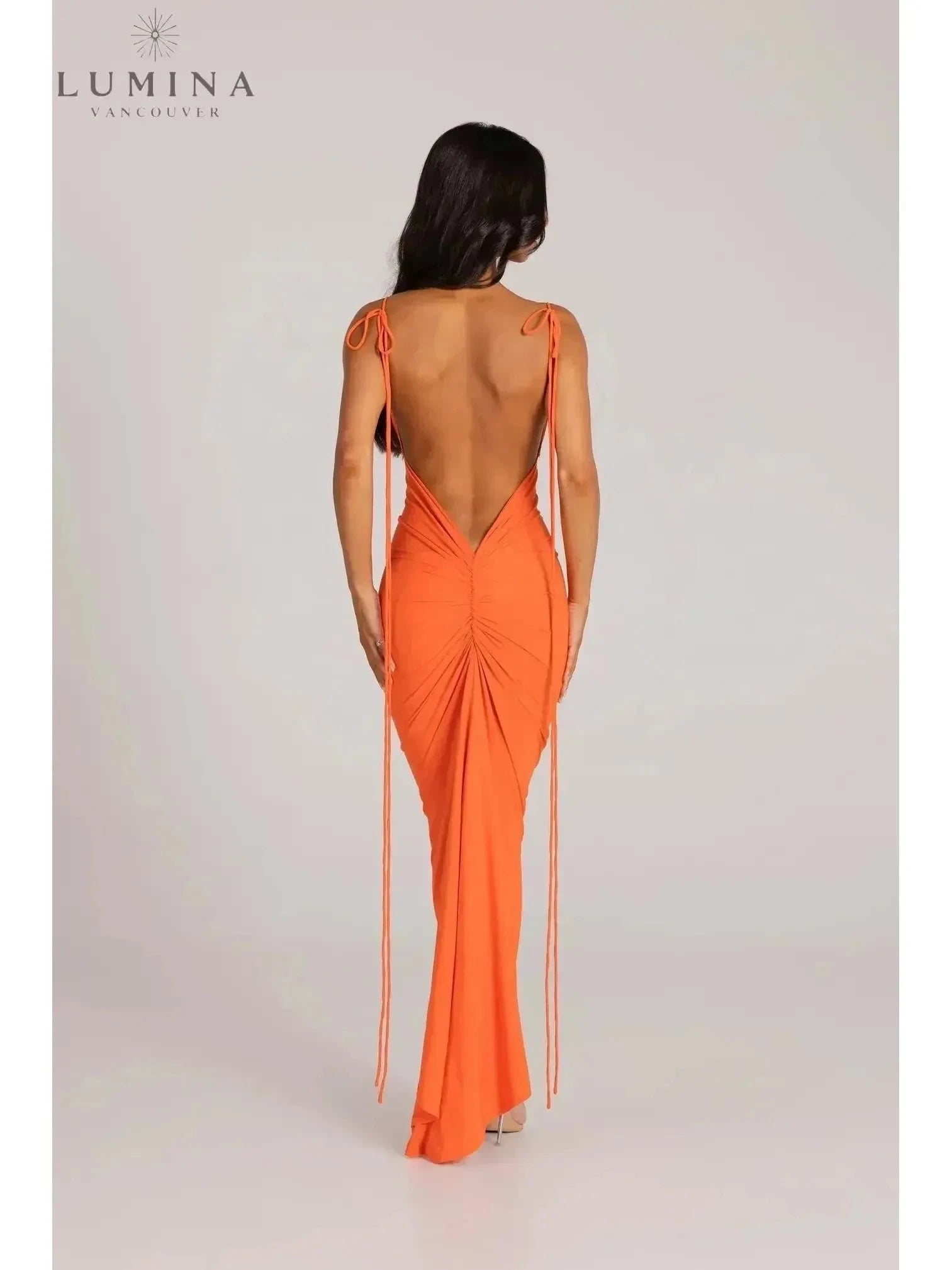 Red Astrid backless maxi dress by Lumina Vancouver, elegant wedding guest gown with flowing fabric and open back design.