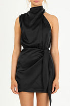 Kaisa Belle satin halter mini dress in apricot by Lumina Vancouver, featuring a sleek halter neckline and smooth satin fabric.