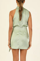 Aurora Belle satin halter mini dress by Lumina Vancouver in apricot color, featuring a sleek fit and elegant halter neckline.