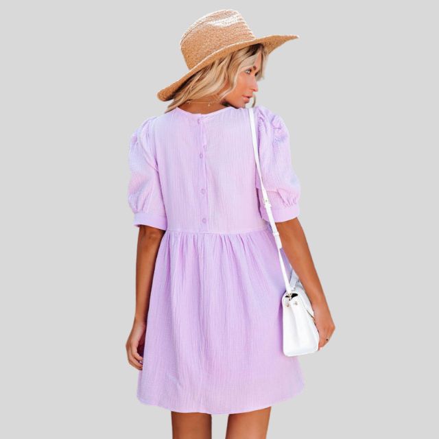 Lumina Wear Lempi Celeste Moonshadow mini dress in vibrant orange, featuring a short, stylish design perfect for summer occasions.