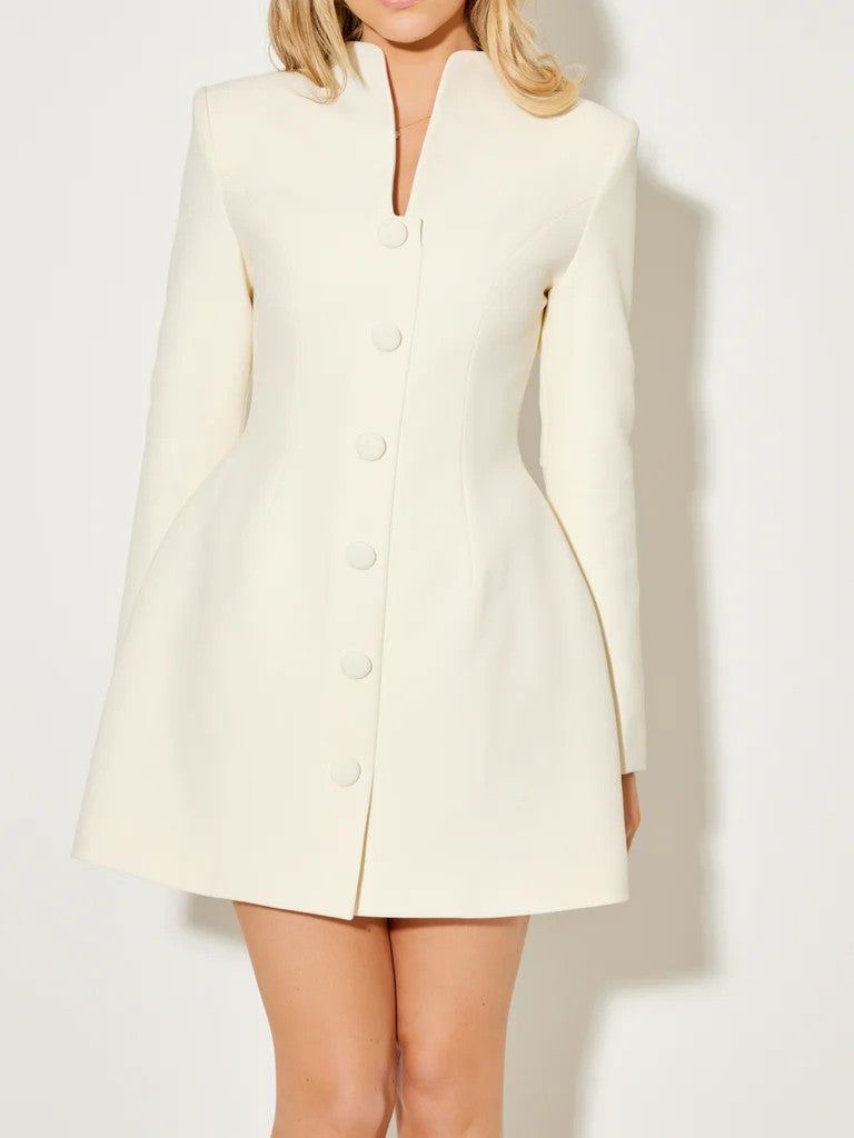 White Aurora coat dress with a statement bow collar by Lumina Vancouver, shown from the front on a model.