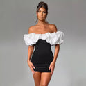 Black and white Aurora off-shoulder mini dress by Lumina Wear, featuring a stylish, fitted silhouette and elegant neckline.