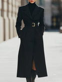 Black Aurora Lumina structured pinstripe belted long coat hanging on a rack, showcasing its tailored design and belt detail.