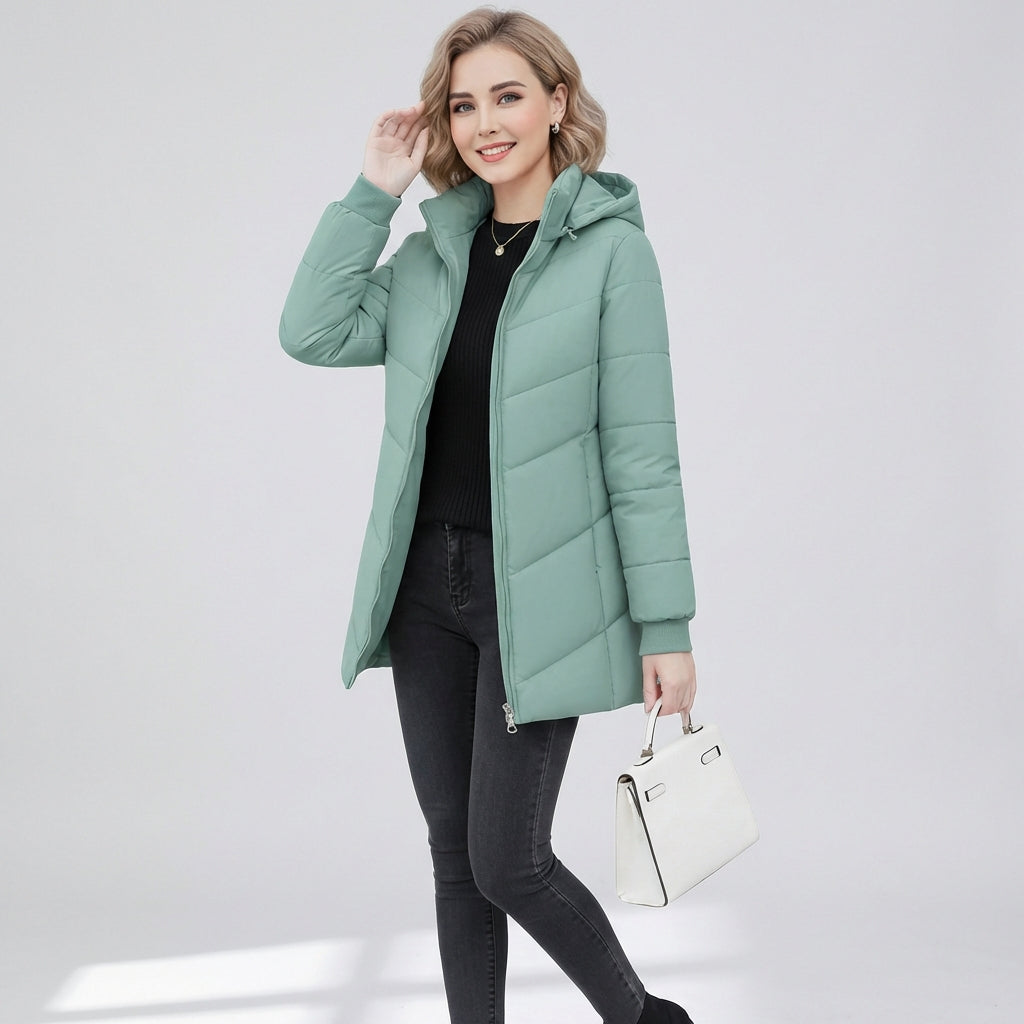 Green Ava Lumina Wear quilted hooded puffer jacket with a sleek, streamlined fit, shown on a model in size XS.