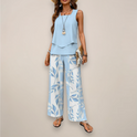 A vibrant printed wide-leg set by Lumina Wear featuring a relaxed fit, in blue, worn by a woman.