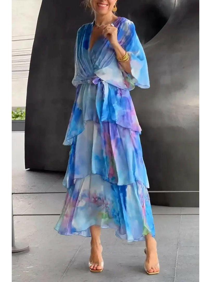 Light blue Avalance maxi dress by Lumina Wear featuring elegant multi-color patterns and flowing fabric.