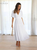 Cream Avalon dress with puff sleeves by Lumina Wear, featuring a stylish design suitable for wedding guests.