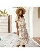 A white Ayesha™ printed summer dress by Lumina Vancouver displayed on a mannequin, perfect for warm weather.