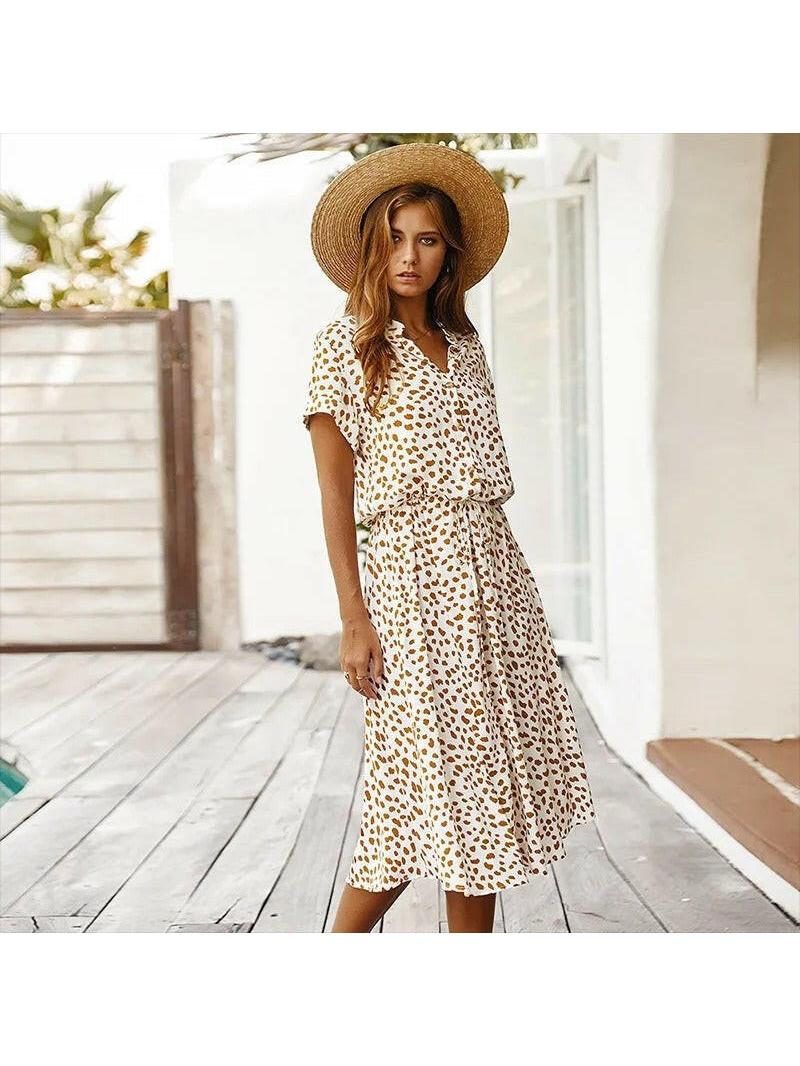 A white Ayesha™ printed summer dress by Lumina Vancouver displayed on a mannequin, perfect for warm weather.