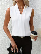 White women's blouse by Lumina Wear featuring elegant pleated design and V-neck, styled as a fashionable, sophisticated top.
