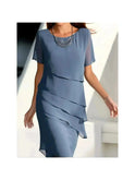 Blue Becci dress by Lumina Wear featuring an elegant design and tummy-flattering fit, showcased on a model.