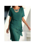 Lumina Wear Becci elegant blue dress with tummy-flattering design, showcased on a model in a well-lit setting.