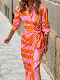 Orange and pink striped midi shirt dress from Lumina Wear featuring a relaxed fit and button-front design.