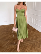 Green Ingunn chic strapless midi dress by Lumina Vancouver, showcasing a fitted waist and elegant midi length.