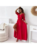 Red Billie V-neck maxi dress with trendy slit skirt by Lumina Wear, shown on a model in a stylish outdoor setting.